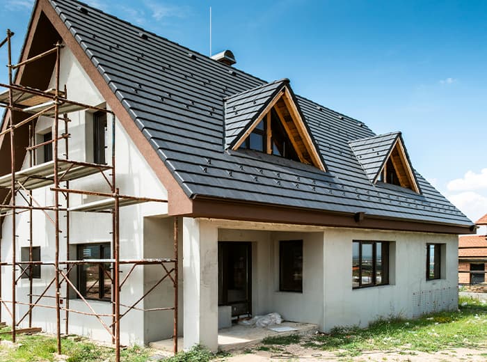 a man is having fun while standing in the middle of a home being built in rural Ottawa