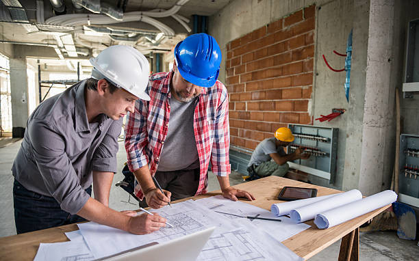 Two people looking over design plans for a new project