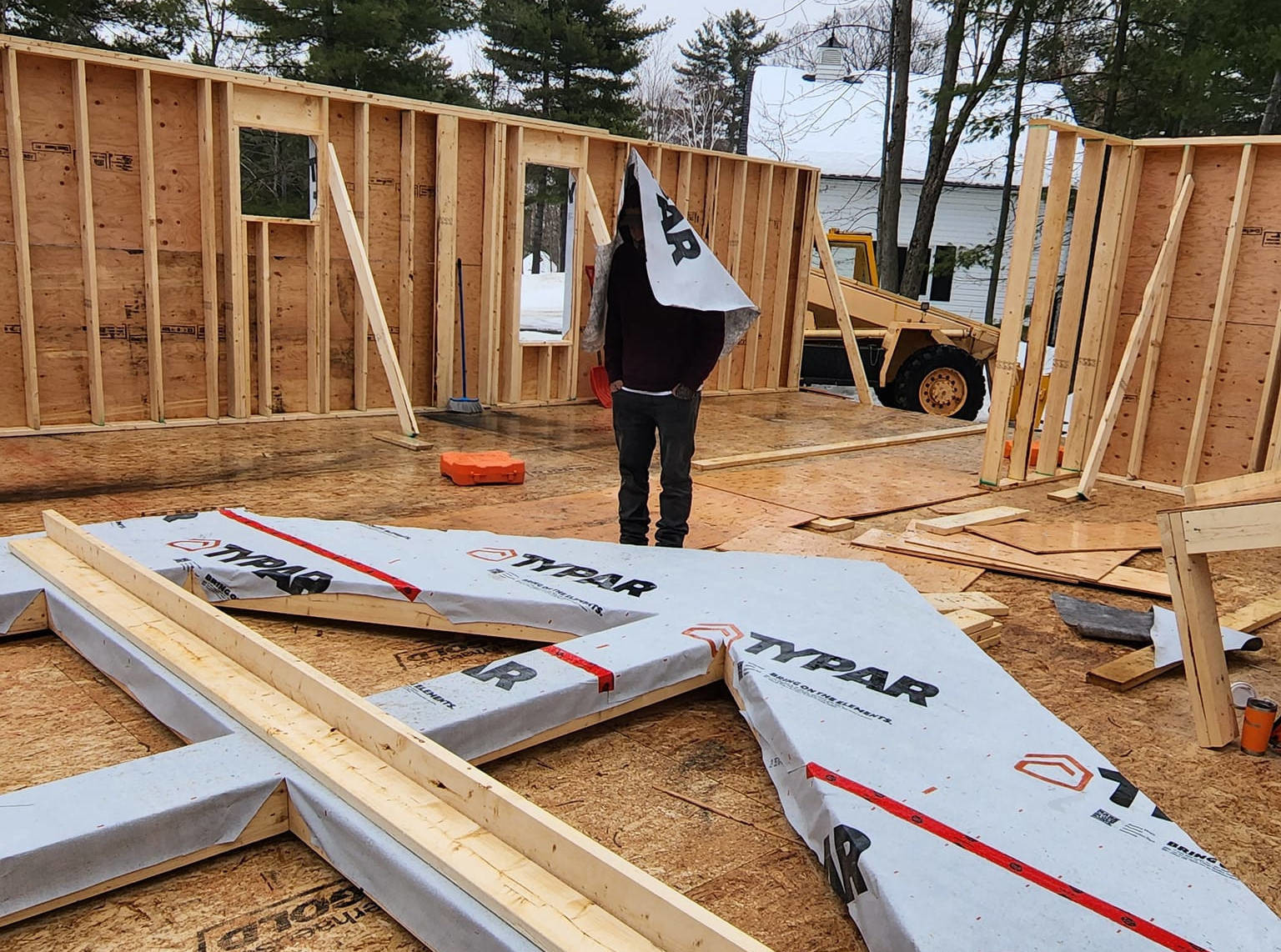 a man is having fun while standing in the middle of a home being built in rural Ottawa