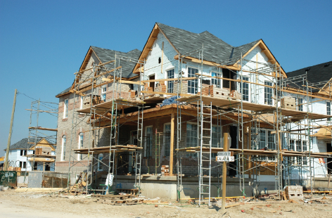 A multi-storey commercial building under construction with glass facades, scaffolding, and crane work highlighting large-scale development.