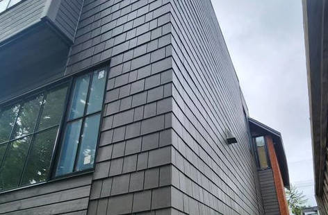 black exterior enveloping on a tall, multi-family home in Ottawa