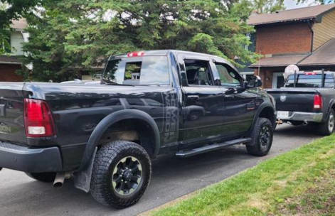 two trucks parked outside a low, multi-family home in Ottawa
